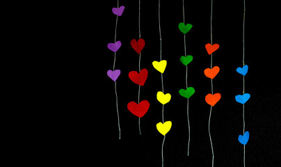 background with coloured hearts on black