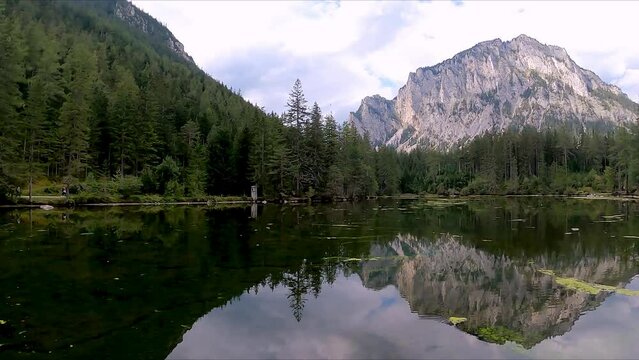 Panoramic view on alpine lake Kreuzteich near Green Lake (Gruener See) in Hochschwab mountain region, Styria, Austria, Europe. Reflection of mountain peaks Messnerin and Pribitz in crystal clear water