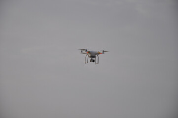 Drone with camera is flying in the nature with space in background
