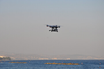 Drone with camera is flying in the nature with space in background
