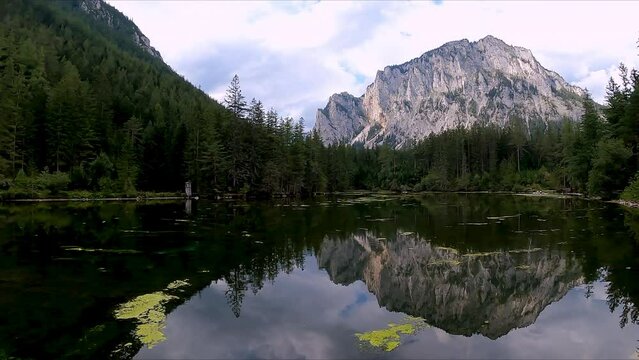 Panoramic view on alpine lake Kreuzteich near Green Lake (Gruener See) in Hochschwab mountain region, Styria, Austria, Europe. Reflection of mountain peaks Messnerin and Pribitz in crystal clear water