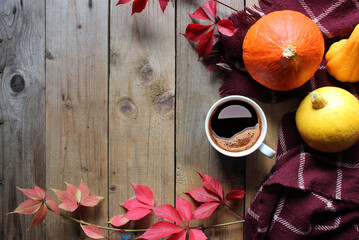 Autumn composition. Pumpkins, fallen leaves, apples, red berries, walnuts on wooden table. Happy Thanksgiving concept. Flat lay, top view, copy space