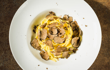 Pasta with fresh truffle mushroom background.Restaurant menu plate background.