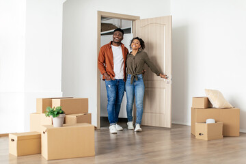 Fototapeta na wymiar African American Husband And Wife Entering Embracing New Home