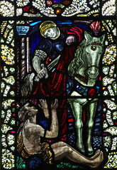 Saint Martin cuts (shares) his coat for a poor person (stained glass window)
