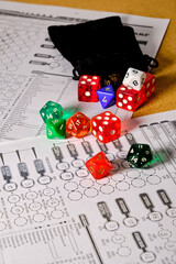 Several role-playing game dice with a role-playing character token, on top of a table.