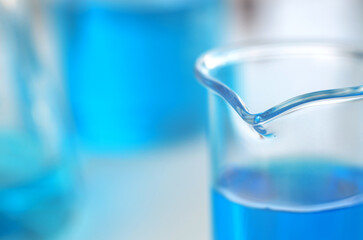 Scientific laboratory research and experiments. Laboratory test tubes with blue liquid close up, selective focus.