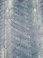 Above old parking lot with arrows and tire skid marks