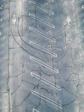 Above Old Parking Lot With Arrows And Tire Skid Marks