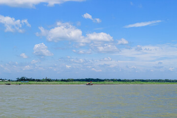 Landscape view small fishing boat on the coast after fishing by fishermen in a small village. It is a small local fishery. Blue sky, white clouds, clear weather.