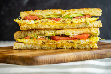 Grilled Omelette Sandwich with Avocado, Tomato, and Sprouts