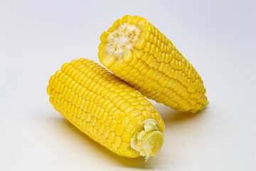 Two halves ear of ripe sweet corn isolated on white background. Isolated. Package design element. Sweet corn without husk. Close-up