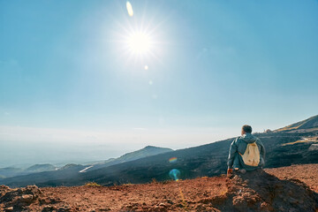 Rear view of mature man enjoying freedom, while admiring panoramic view of colorful summits of...