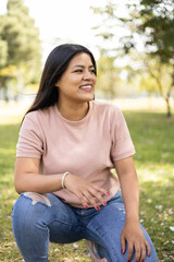 Obraz premium attractive model, posing and resting on a sunny day, wear casual comfortable clothes with straight black hair, outdoor lifestyle