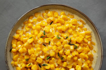 Homemade Slow Cooker Creamed Corn in a Bowl on a gray background, top view. Flat lay, overhead, from above. Close-up.