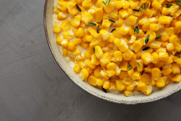 Homemade Slow Cooker Creamed Corn in a Bowl on a gray background, top view. Flat lay, overhead, from above. Close-up.