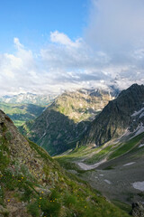 Obraz premium Summer landscape with greats mountains against cloudy sky. beautiful scenic nature view with mountains. natural background. trip, journey, hiking, adventure concept. Caucasus mountains, Arkhyz