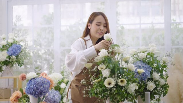 Asian women create lovely floral arrangements to sell.