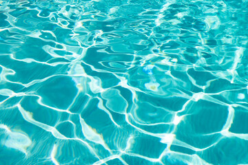 Fototapeta na wymiar blue color background of swimming pool water with ripples in summertime