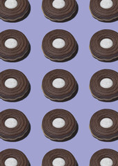 Stacked round biscuits topped with white chocolate cream isolated over blue background.