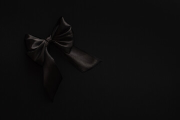 Closeup black bow on a black background, blackFriday concept