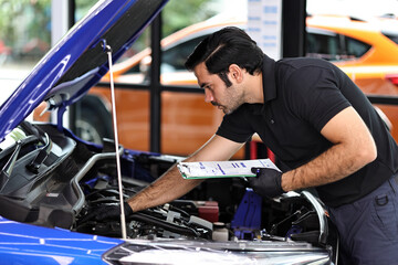 Fototapeta na wymiar Car mechanic working with a Service checking car engine 