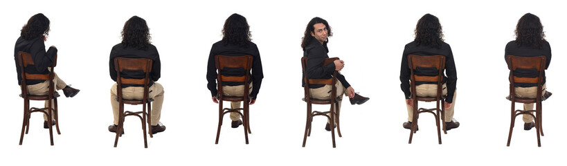  back view of same man with shoes and shirt sitting on chair turned and looking at camera on white...
