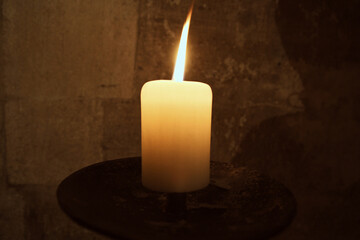 burning candle in the dark light