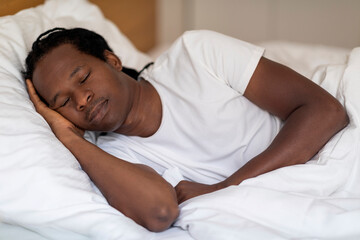 Portrait Of Calm Young Black Man Sleeping In Comfortable Bed At Home