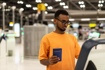 Young black man ready to travel at airport terminal waiting for flight