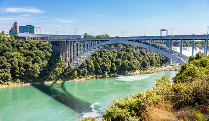 The arched Rainbow Bridge spans the Niagara gorge and Niagara River connecting Niagara Falls Ontario Canada to Niagara Falls New York USA.