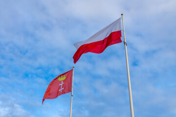 Flags of Poland and Gdańsk on the sky