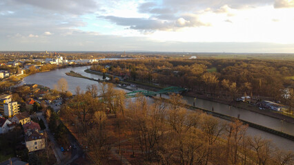 Top view of the city Opole. The Odra River flows through the city, dry trees on the banks. Poland, winter