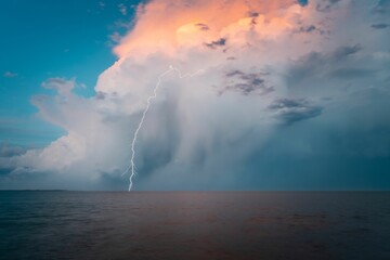 Beautiful shot of a cloudscape and lightning strike over a sea