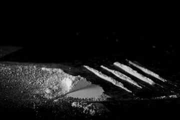 Cocaine line isolated on black, side view   - obrazy, fototapety, plakaty