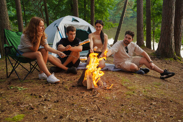 Photo of friends travelers having good time together on weekend in forest trip.