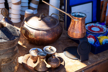Preparation of Turkish coffee in a copper cezve and presentation of coffee on a copper tray.