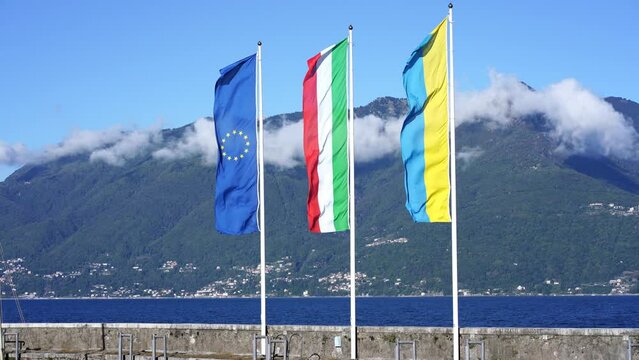 Ukrainian flag along with the Italian and European flags in Luino on Lake Maggiore.