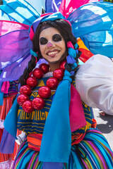 Portrait of a Mexican woman dressed up for the celebration of the Day of the dead.
Smiling girl resembling a skull make up in Mexico
