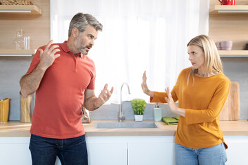 Fototapeta premium Emotional spouses having fight at home, shouting at each other