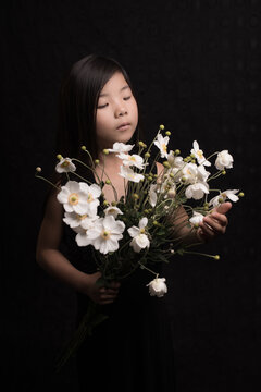 portrait of a an asian girl with white Japanese Anemone  flowers