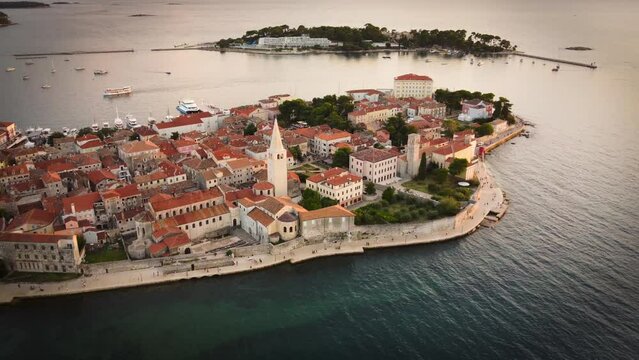 Drone view of a beautiful island with old buildings during sunset