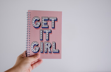 woman holding a get it girl sign notebook journal 