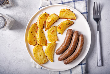 Fried sausages with roasted potato slices