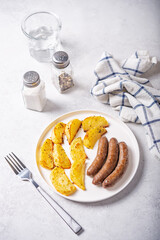 Fried sausages with roasted potato slices