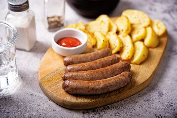 Fried sausages with roasted potato slices