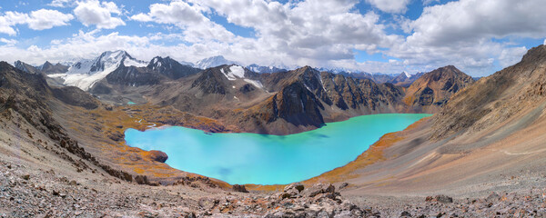 Panoramic landscape with lake and mountains; heart in the mountains, Ala-kul lake from Ala-kul pass during hike near Karakol in Kyrgyzstan