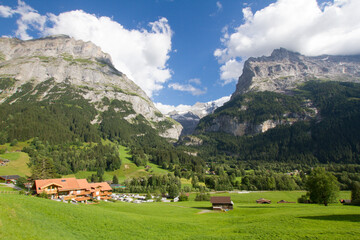 Fototapeta na wymiar Alpine village surrounded by Mountains in Grindelwald, Switzerland