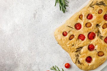 Italian focaccia bread with garlic, cherry tomatoes, rosemary and olive oil. Freshly homemade baked...