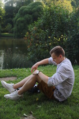 Smiling young man sitting near pound